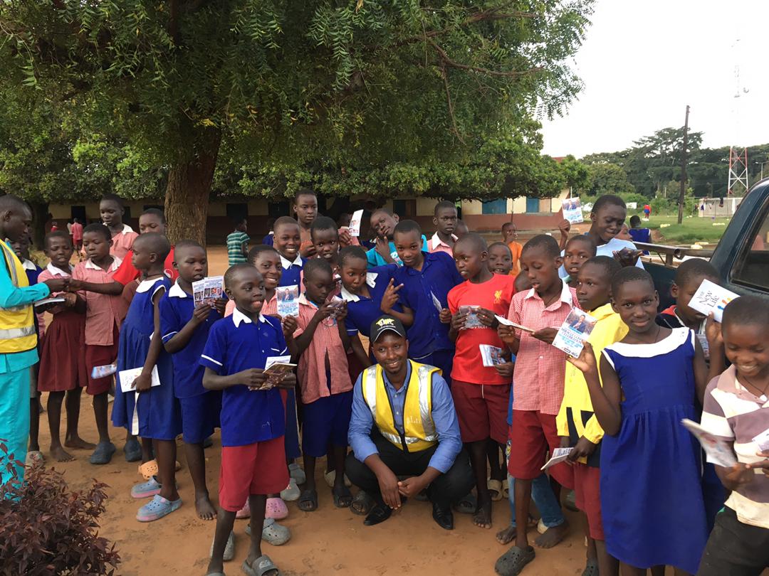 Group of students holding newly received Christian books