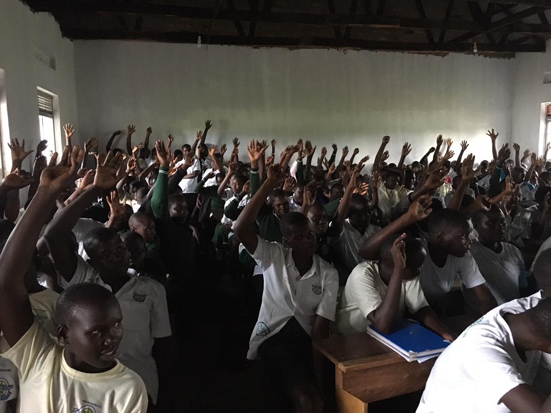 Classroom filled with students receiving educational supplies
