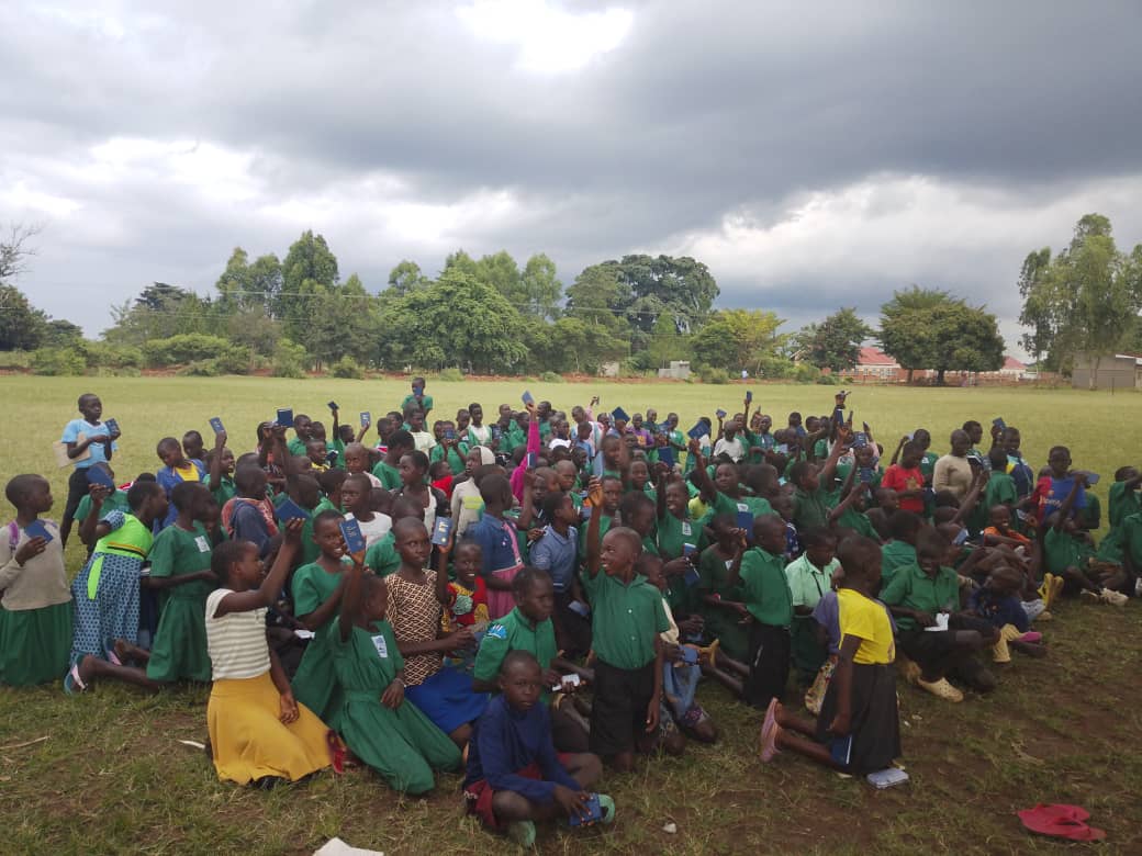 Pupils raising scholastic materials distributed in classrooms