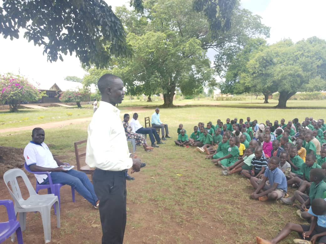 Outdoor gathering for book and sports supplies distribution